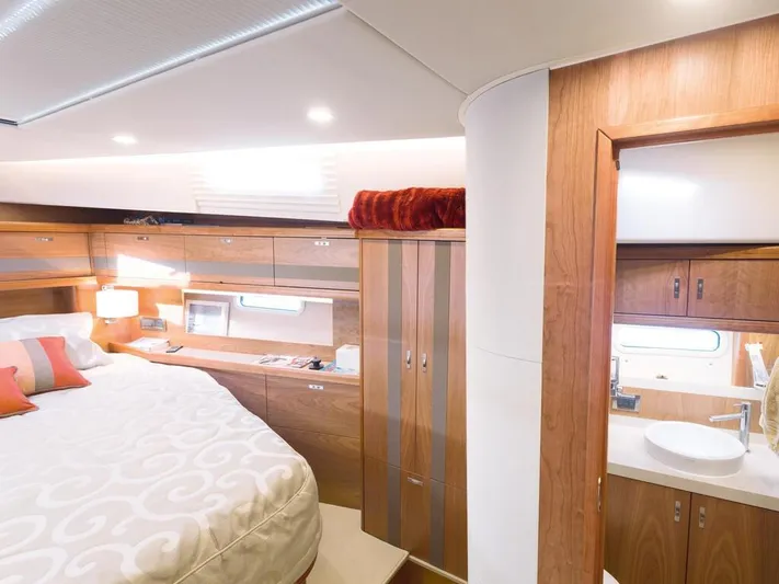  Yacht Photos Pics Luxurious interior of 2025 Moody 54 DS yacht with elegant wood finishes and cozy bedroom.