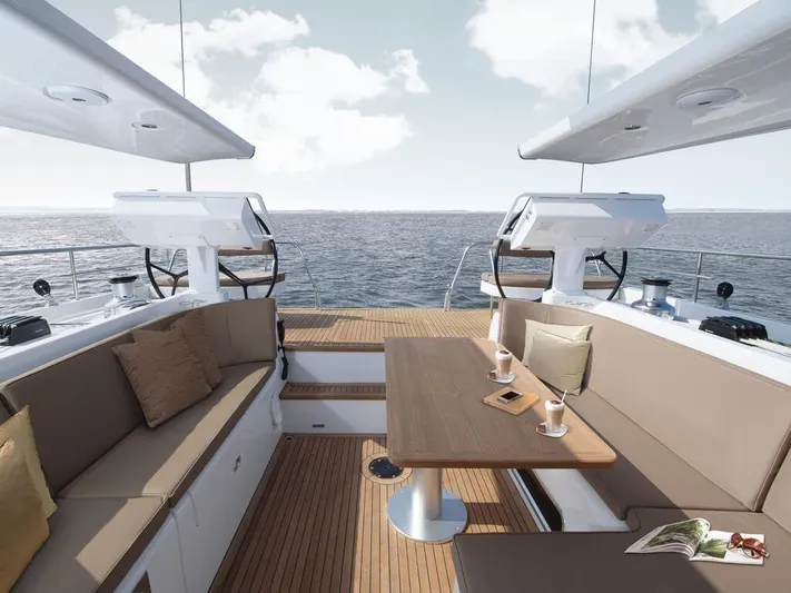  Yacht Photos Pics Luxurious Moody 54 DS yacht deck with seating, table, and ocean view, 2025 model.