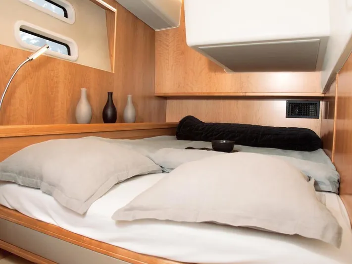  Yacht Photos Pics Luxurious cabin interior of 2025 Moody 54 DS yacht with cozy bedding and elegant decor.