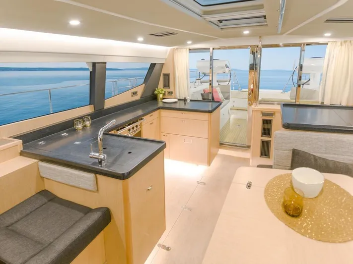  Yacht Photos Pics Luxurious interior of 2025 Moody 54 DS yacht with modern kitchen and ocean view.