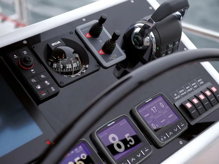  Yacht Photos Pics Control panel of 2025 Moody 54 DS yacht with navigation instruments and throttle.