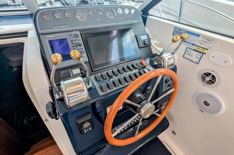  Yacht Photos Pics 2005 Tiara Yachts 3200 Open helm with wooden steering wheel and modern navigation controls.