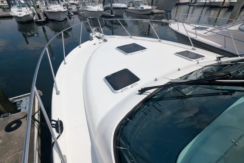  Yacht Photos Pics 2005 Tiara Yachts 3200 Open docked at marina, showcasing sleek design and spacious deck.