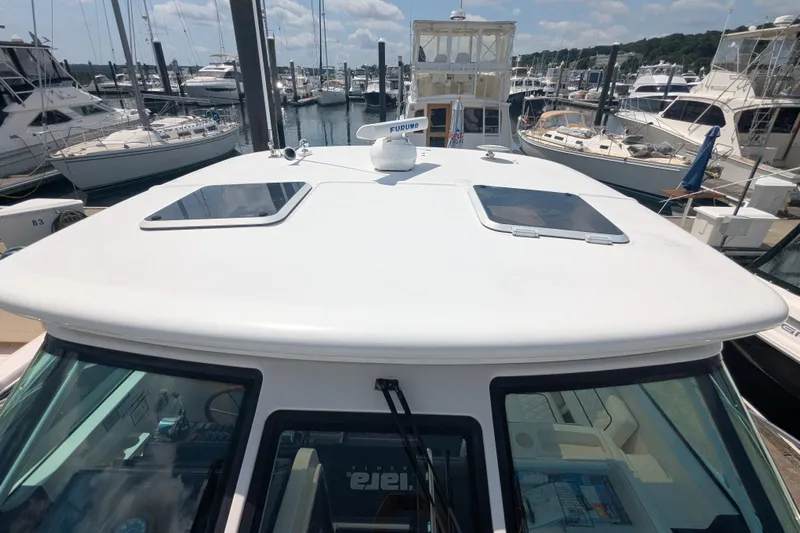  Yacht Photos Pics 2005 Tiara Yachts 3200 Open at marina, showcasing sleek design and spacious deck.