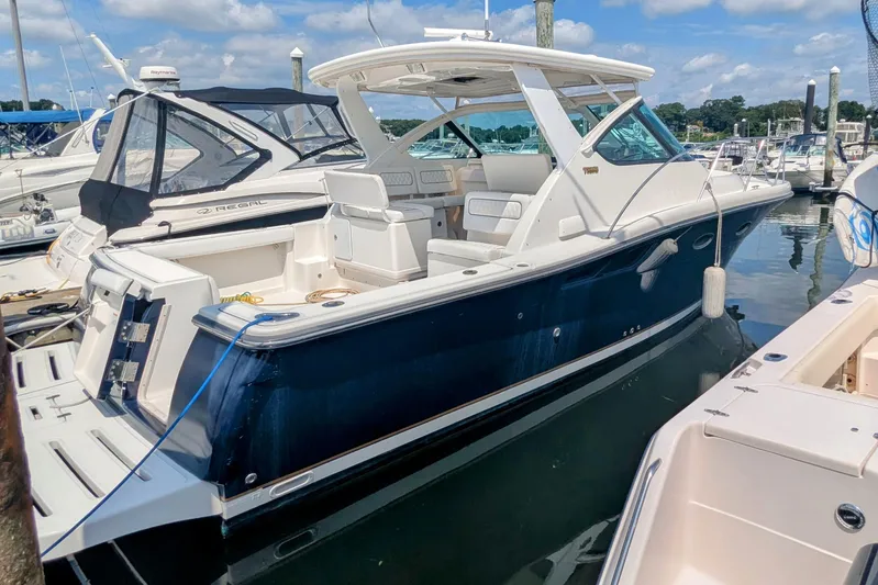  Yacht Photos Pics 2005 Tiara Yachts 3200 Open docked at marina under blue sky.