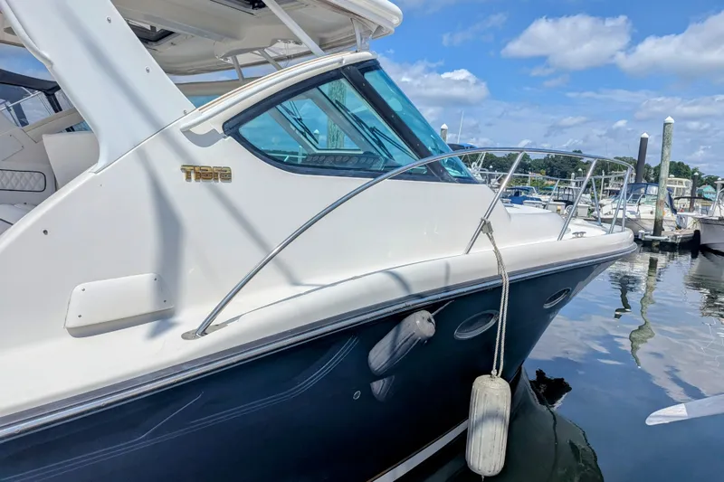  Yacht Photos Pics 2005 Tiara Yachts 3200 Open docked at marina, featuring sleek design and clear blue skies.