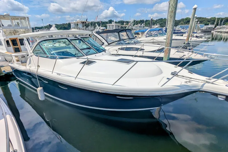  Yacht Photos Pics 2005 Tiara Yachts 3200 Open docked in a marina under a blue sky.