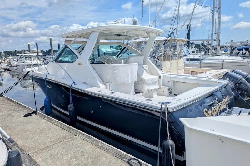  Yacht Photos Pics 2005 Tiara Yachts 3200 Open docked at marina under blue sky.