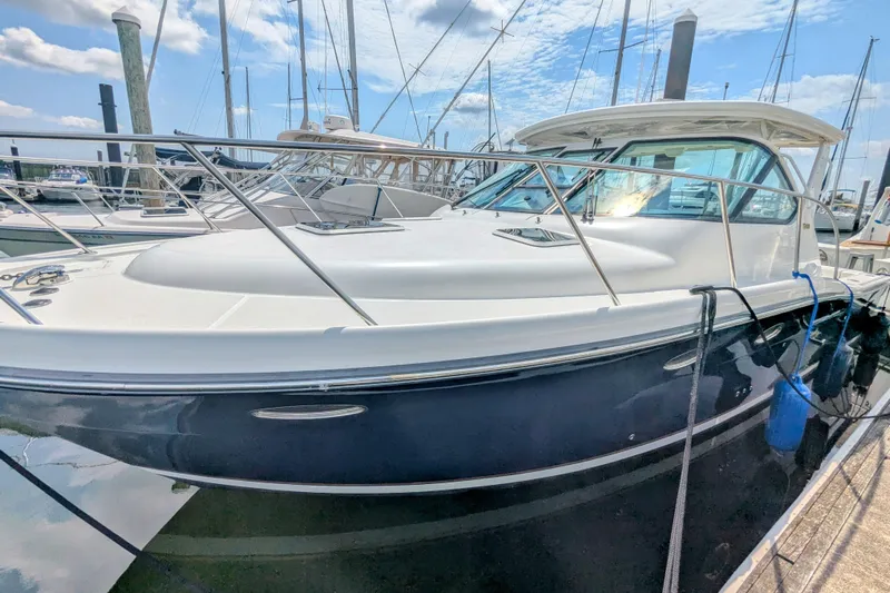  Yacht Photos Pics 2005 Tiara Yachts 3200 Open docked, showcasing sleek design and polished exterior.