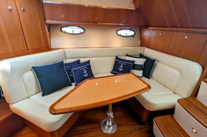  Yacht Photos Pics Luxurious 2005 Tiara Yachts 3200 Open interior with cozy seating and nautical-themed cushions.