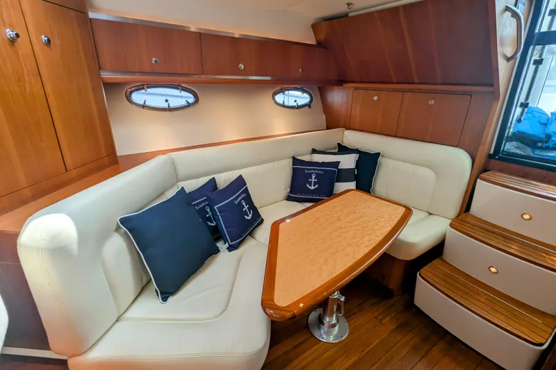  Yacht Photos Pics 2005 Tiara Yachts 3200 Open interior with cozy seating and nautical-themed cushions.