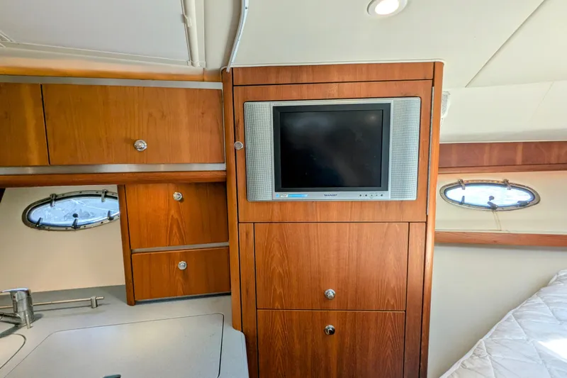  Yacht Photos Pics 2005 Tiara Yachts 3200 Open interior with wood cabinetry and built-in TV.