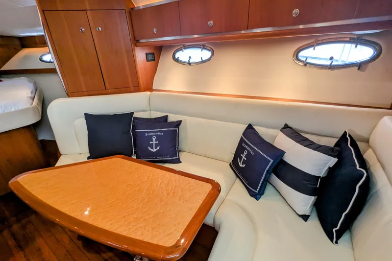  Yacht Photos Pics Interior of 2005 Tiara Yachts 3200 Open with cozy seating and nautical-themed cushions.