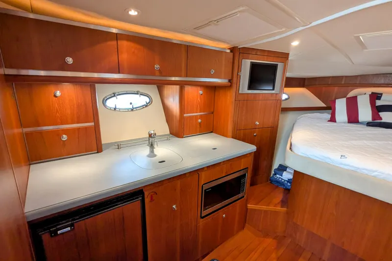  Yacht Photos Pics Luxurious 2005 Tiara Yachts 3200 Open interior with kitchenette and cozy sleeping area.