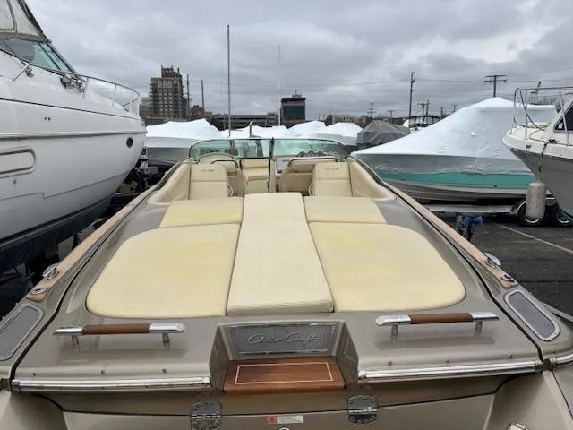  Yacht Photos Pics 2014 Chris-Craft Launch 32 boat with beige seating, docked in a marina.