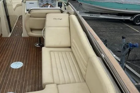 Yacht Photos Pics 2014 Chris-Craft Launch 32 interior with beige leather seating and wooden flooring.