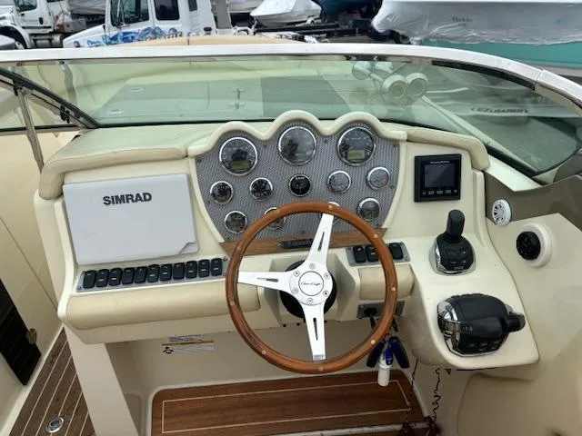  Yacht Photos Pics 2014 Chris-Craft Launch 32 dashboard with Simrad navigation and wooden steering wheel.