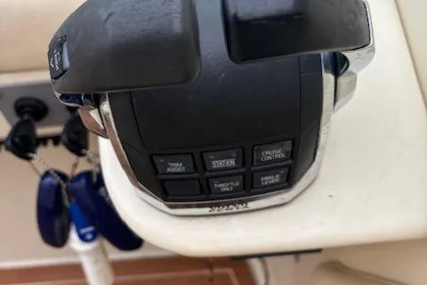  Yacht Photos Pics Close-up of 2014 Chris-Craft Launch 32 throttle controls with buttons and key fobs.