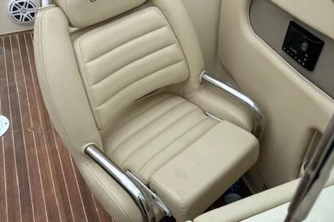  Yacht Photos Pics 2014 Chris-Craft Launch 32 boat seat with beige upholstery and chrome armrests.