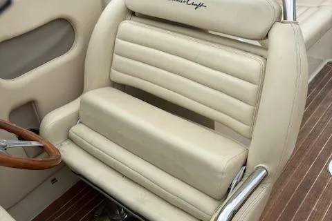  Yacht Photos Pics 2014 Chris-Craft Launch 32 boat seat with beige upholstery and wooden accents.