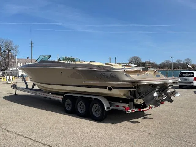  Yacht Photos Pics 2014 Chris-Craft Launch 32 boat on trailer, parked outdoors under clear sky.