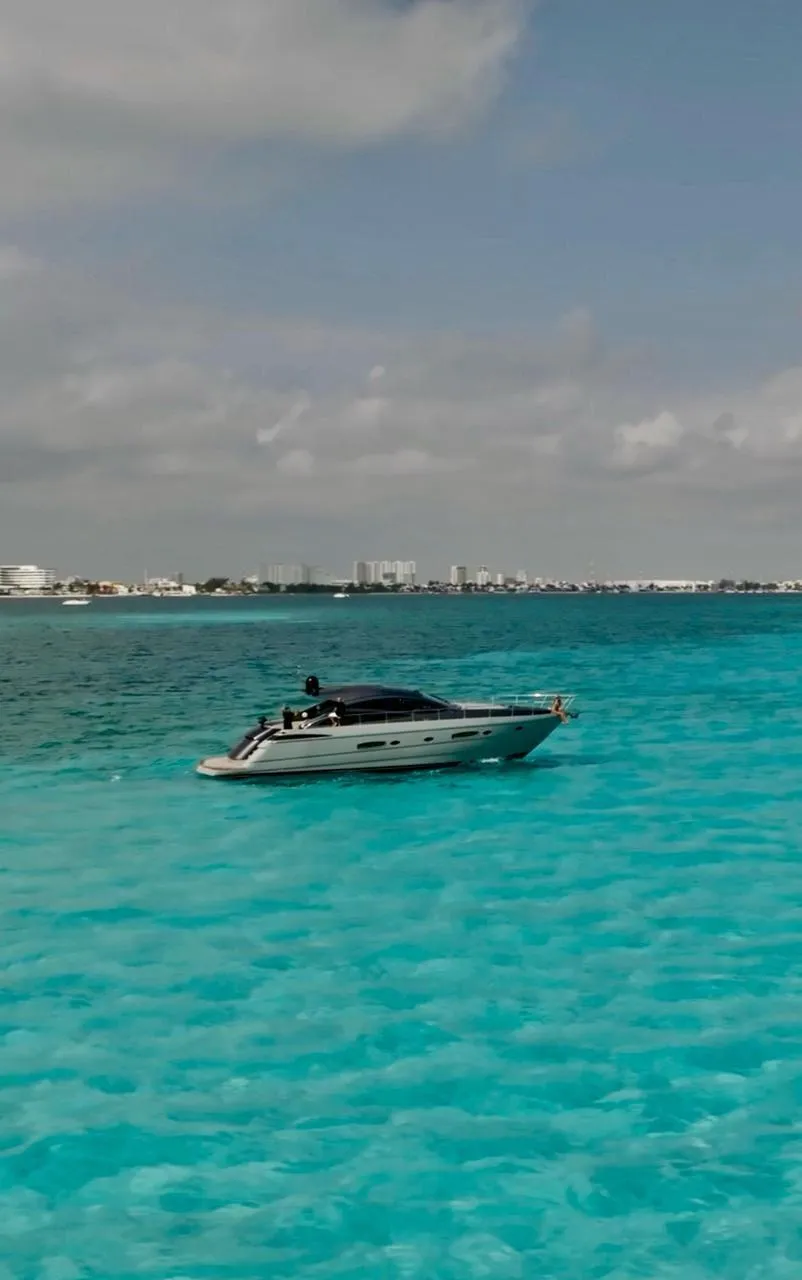 Luxury Pershing 56 yacht cruising in turquoise waters, 2009 model.