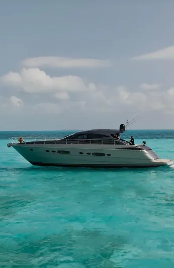 Lupo Yacht Photos Pics 2009 Pershing 56 yacht cruising on clear turquoise waters under a blue sky.