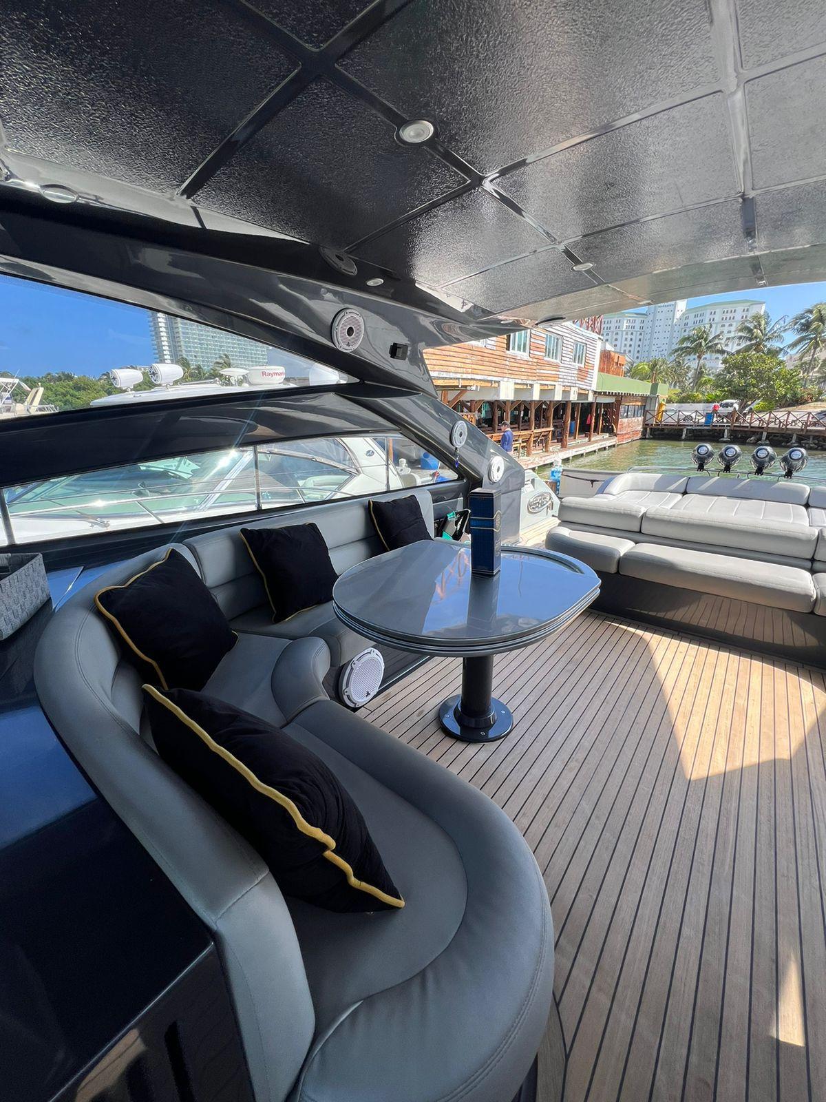 Luxurious 2009 Pershing 56 yacht interior with elegant seating and table.