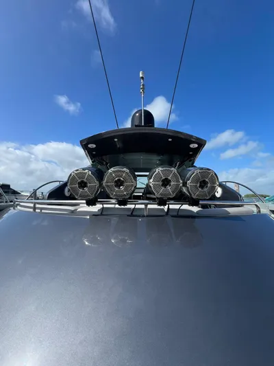 Lupo Yacht Photos Pics 2009 Pershing 56 yacht with speakers, under a clear blue sky.