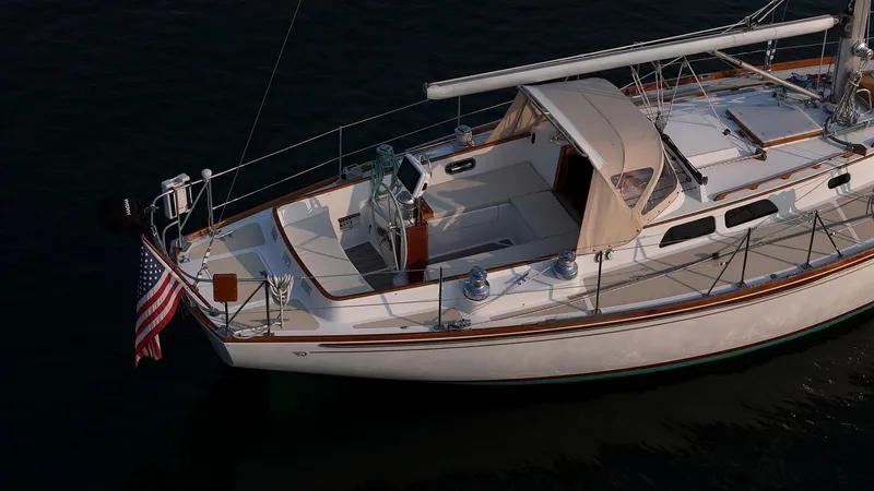 Loon Yacht Photos Pics 1988 Hinckley Sou'wester 42 sailboat with American flag, docked on calm water.