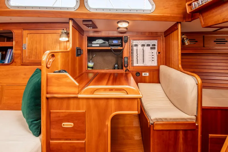 Loon Yacht Photos Pics Hinckley Sou'wester 42 yacht interior, 1988 model, featuring a wooden navigation station and seating area.