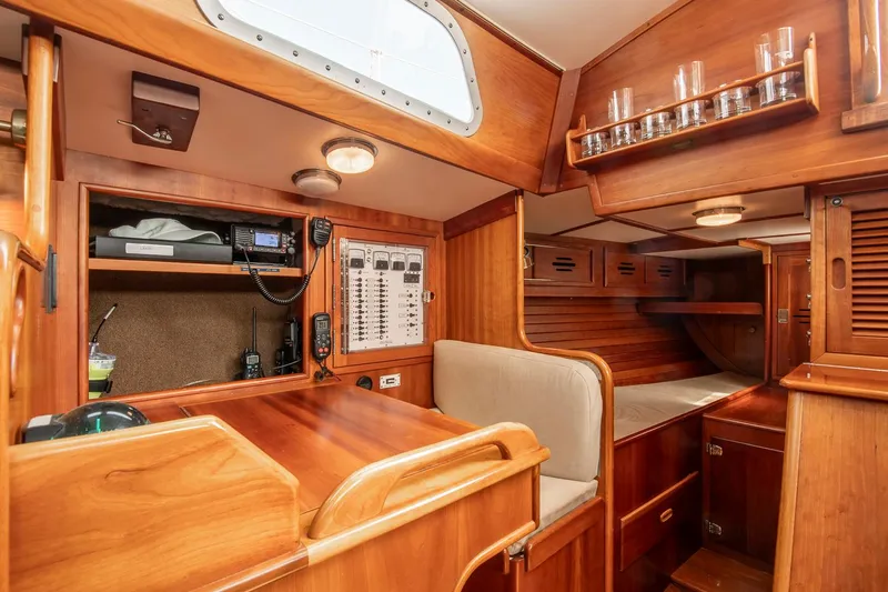 Loon Yacht Photos Pics 1988 Hinckley Sou'wester 42 yacht interior with navigation station and cozy wooden cabin.