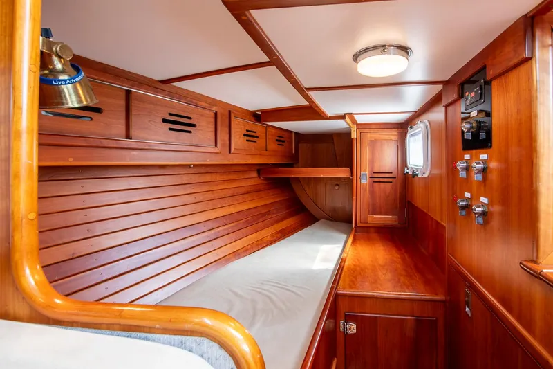 Loon Yacht Photos Pics Interior of 1988 Hinckley Sou'wester 42 sailboat with wooden paneling and cozy berth.