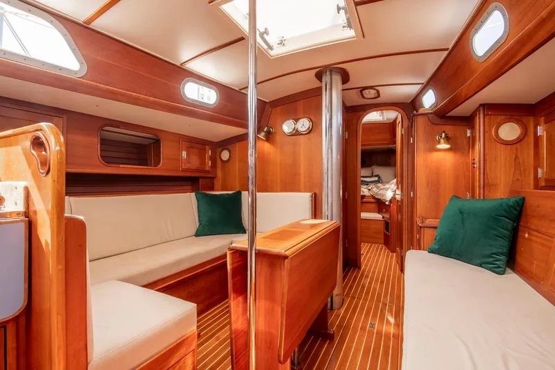 Loon Yacht Photos Pics Interior of 1988 Hinckley Sou'wester 42 sailboat with wooden furnishings and cozy seating.