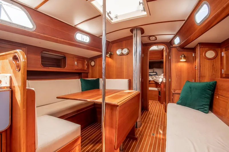 Loon Yacht Photos Pics Interior of 1988 Hinckley Sou'wester 42 sailboat with wooden furnishings and cozy seating.