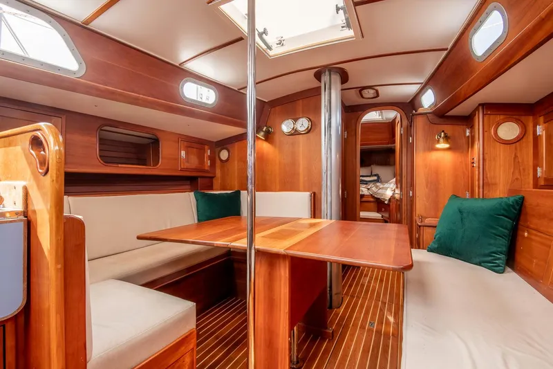 Loon Yacht Photos Pics Interior of 1988 Hinckley Sou'wester 42 sailboat with wooden furnishings and cozy seating area.