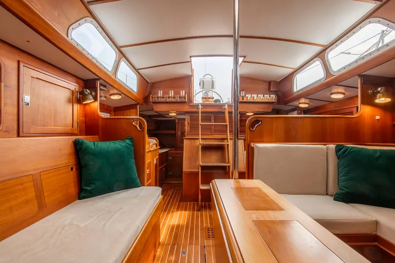 Loon Yacht Photos Pics Interior of 1988 Hinckley Sou'wester 42 sailboat, featuring elegant woodwork and cozy seating.