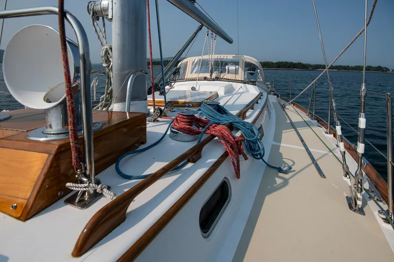 Loon Yacht Photos Pics 1988 Hinckley Sou'wester 42 sailboat deck with ropes and wooden details on calm water.