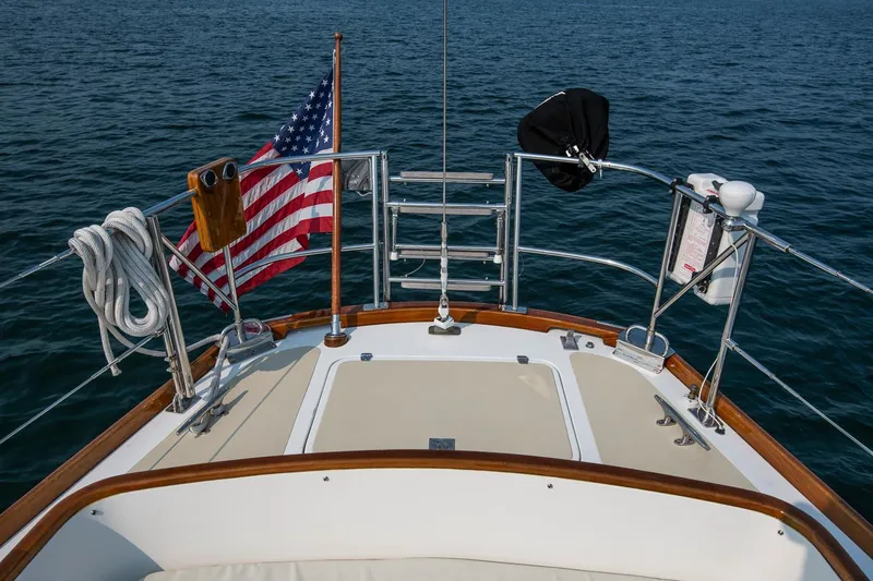 Loon Yacht Photos Pics Hinckley Sou'wester 42 sailboat deck with American flag, 1988 model, on open water.