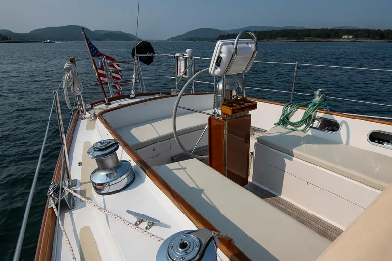 Loon Yacht Photos Pics 1988 Hinckley Sou'wester 42 sailboat cockpit with American flag, scenic water view.