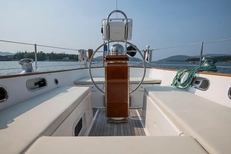 Loon Yacht Photos Pics 1988 Hinckley Sou'wester 42 sailboat cockpit with steering wheel, seating, and scenic water view.
