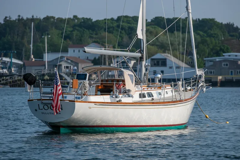 Loon Yacht Photos Pics Hinckley Sou'wester 42 sailboat from 1988 on calm water, with American flag.