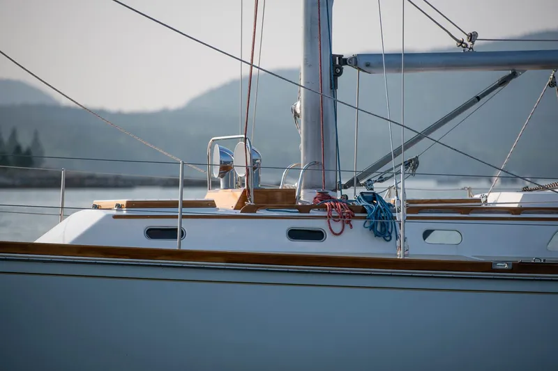 Loon Yacht Photos Pics 1988 Hinckley Sou'wester 42 sailboat with ropes and mast, docked near mountains.
