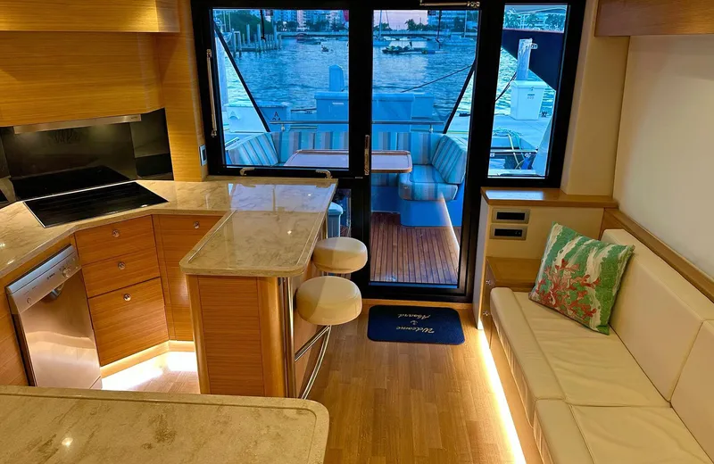 Oasis Yacht Photos Pics Luxurious 2021 Outer Reef Trident 620 yacht interior with elegant kitchen and seating area.