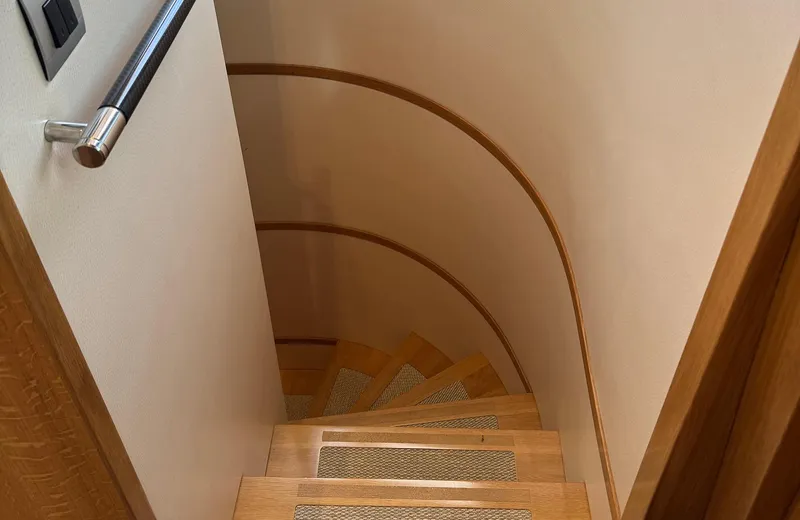 Oasis Yacht Photos Pics Wooden spiral staircase inside 2021 Outer Reef Trident 620 yacht.