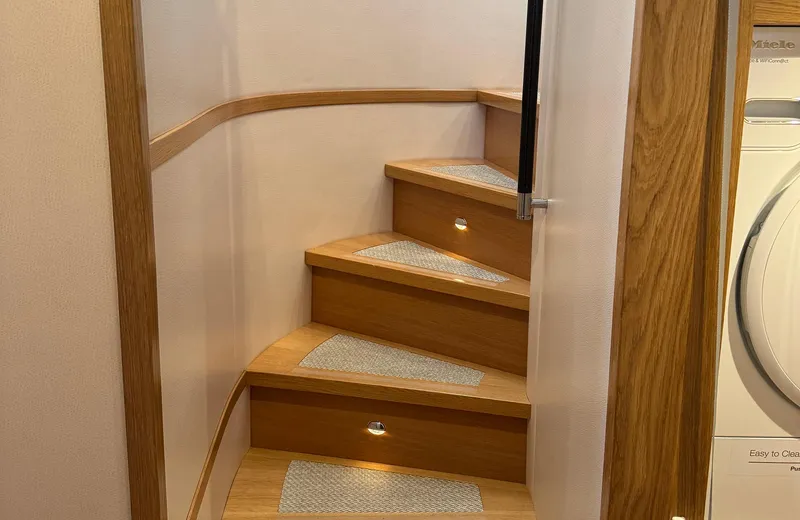 Oasis Yacht Photos Pics Wooden staircase with built-in lights on an Outer Reef Trident 620 yacht, 2021 model.