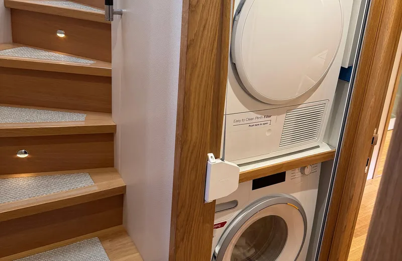 Oasis Yacht Photos Pics Laundry area with stacked washer and dryer in 2021 Outer Reef Trident 620 yacht.