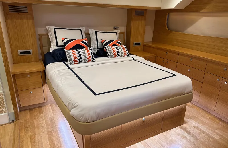 Oasis Yacht Photos Pics Luxurious bedroom interior of 2021 Outer Reef Trident 620 yacht with modern wood cabinetry.