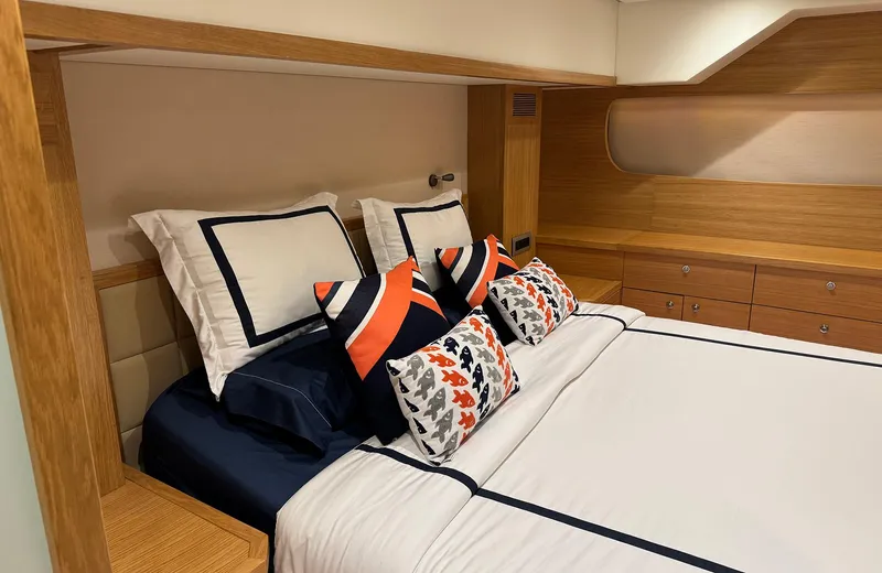 Oasis Yacht Photos Pics Luxurious bedroom interior of 2021 Outer Reef Trident 620 yacht with elegant bedding.