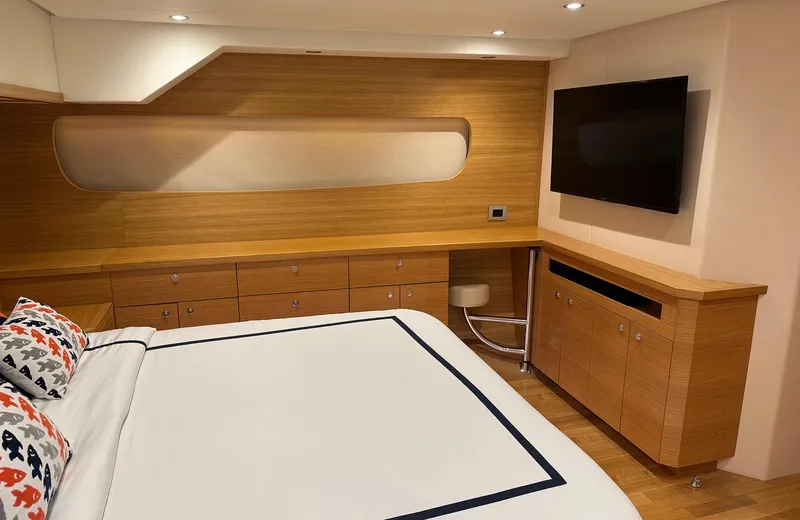 Oasis Yacht Photos Pics Luxurious bedroom interior of 2021 Outer Reef Trident 620 yacht with modern wood finishes.